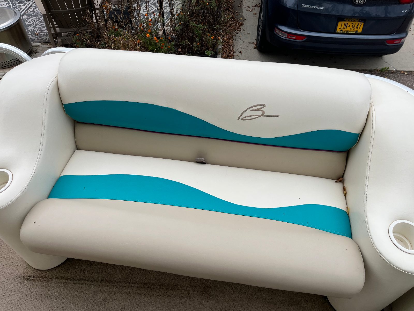 Bennington pontoon seats after detailing — bright clean white and teal vinyl